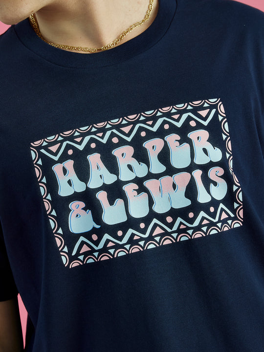 Detailed image of the Taran tee in Navy, the colour on this abstract design are pink and blue.