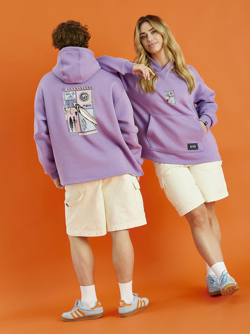 Both models wearing the Cruz hooded sweatshirt in Purple, constructed from plush fleece-back jersey, this hoodie offers a warm and cosy interior, ideal for everyday comfort.