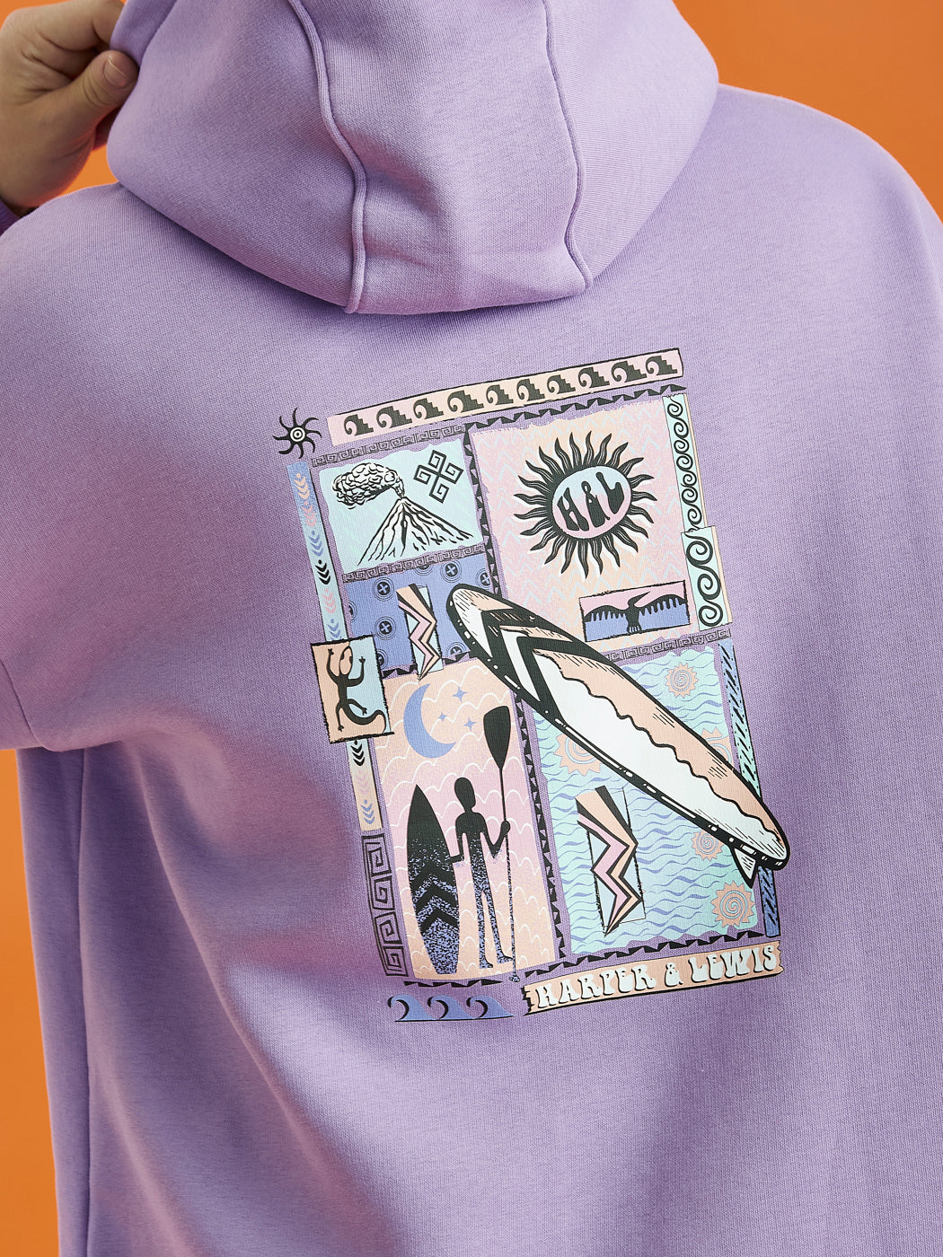 Male Model wearing the Cruz Hoodie in Purple, this is showing the back print on the, which is tribal inspired with a surfboard.