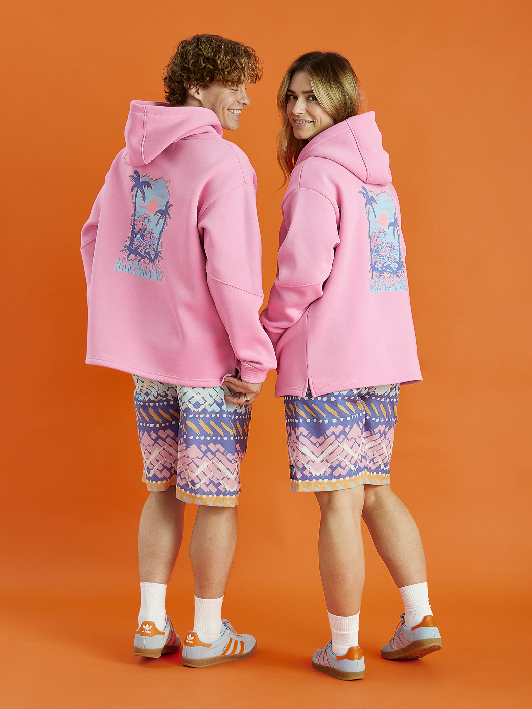 Both models wearing the Cruz hooded sweatshirt in Pink, constructed from plush fleece-back jersey, this hoodie offers a warm and cosy interior, ideal for everyday comfort.