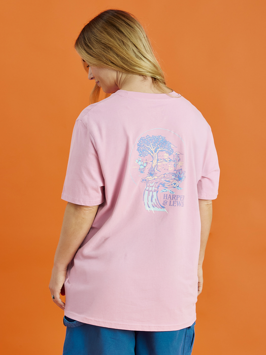Female Model showing the back of the pink Aura tee. This shows the back graphic which is the tree of life, giving a boho vibe.