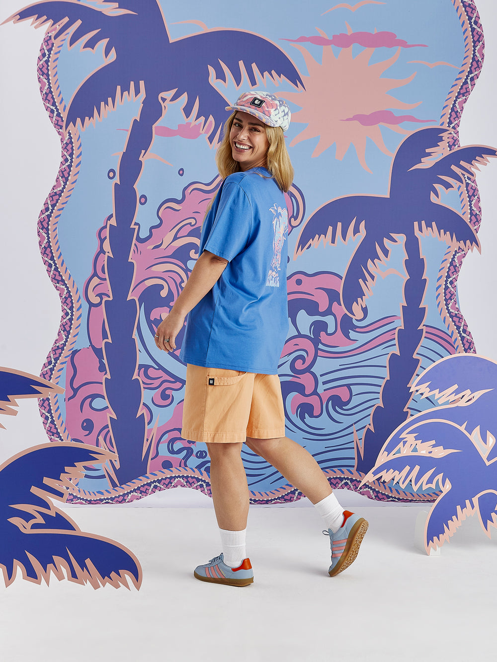 Detail shot of the tropical graphic print which features colours of Blue, light blue, peach and dusty pink.