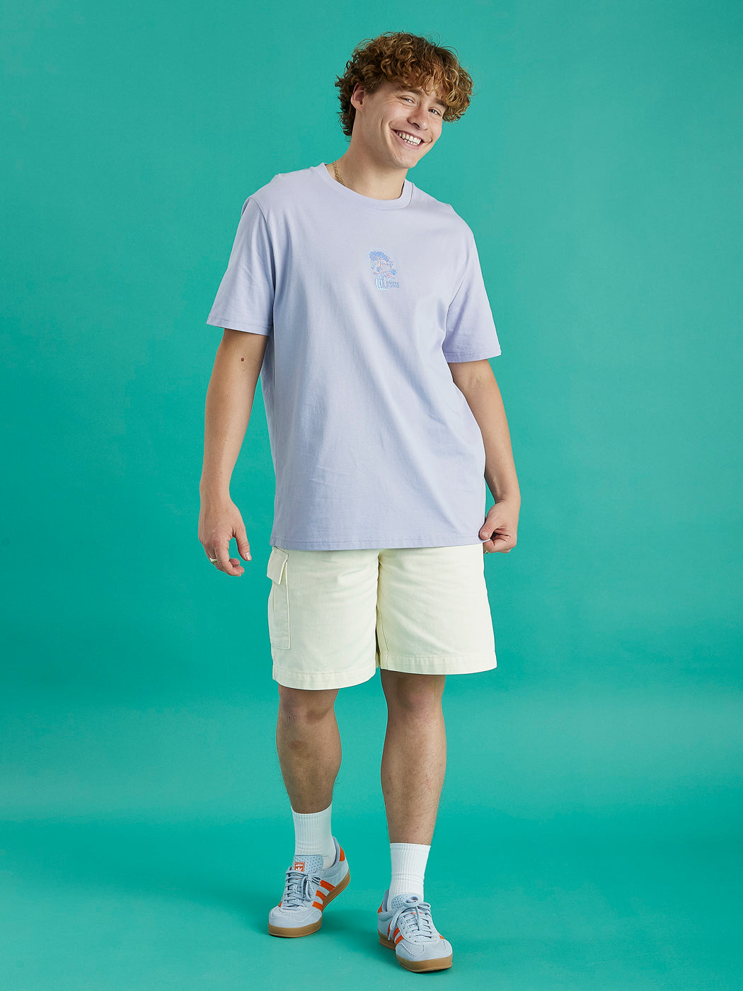 Male model showing the lavender aura tee. This has a relaxed fit and has a front and back graphic