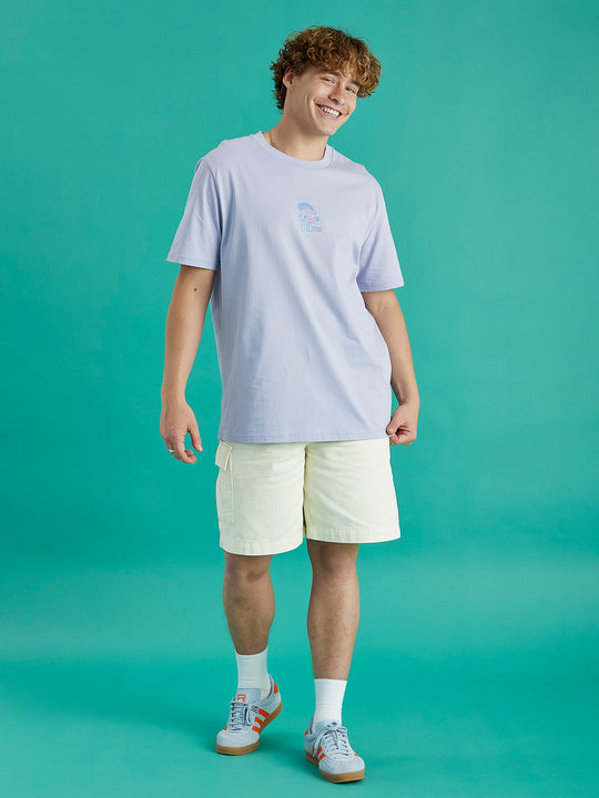 Male model showing the lavender aura tee. This has a relaxed fit and has a front and back graphic