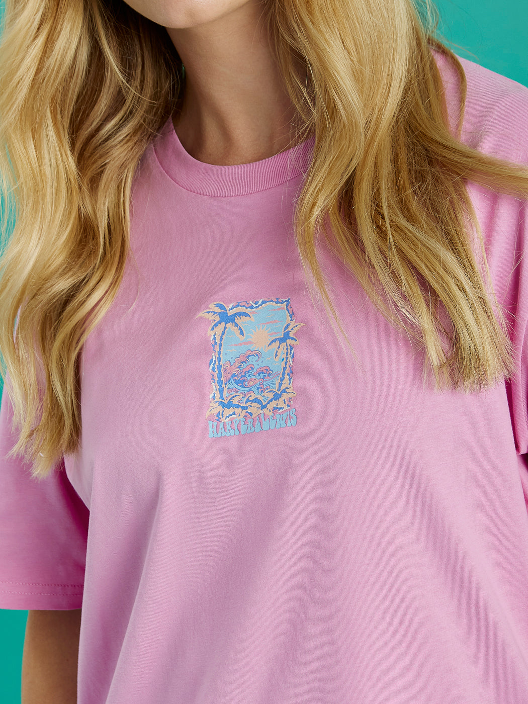 The front graphic features palm trees and a sunset with waves.