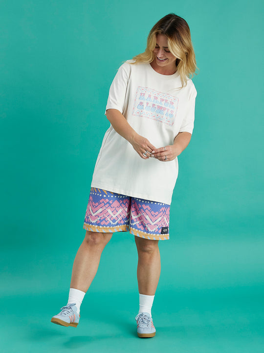 Female model wearing the Taran tee casually with abstract pattern shorts.