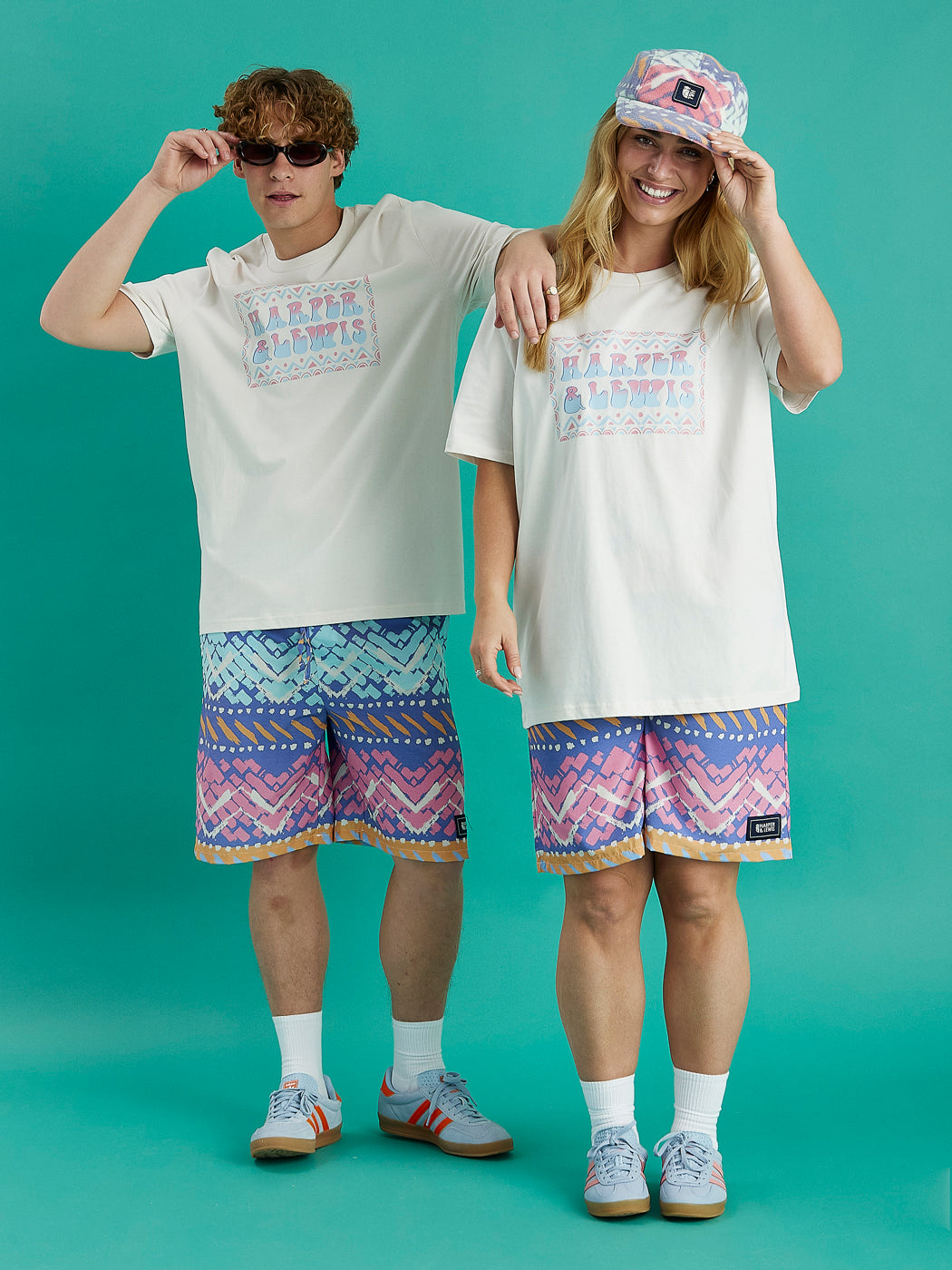 Both Models wearing the Cove Shorts, these shorts are brilliantly patterned in pale hues of apricot, cream, pink, mint, airforce & cornflower blue creating a standout look.