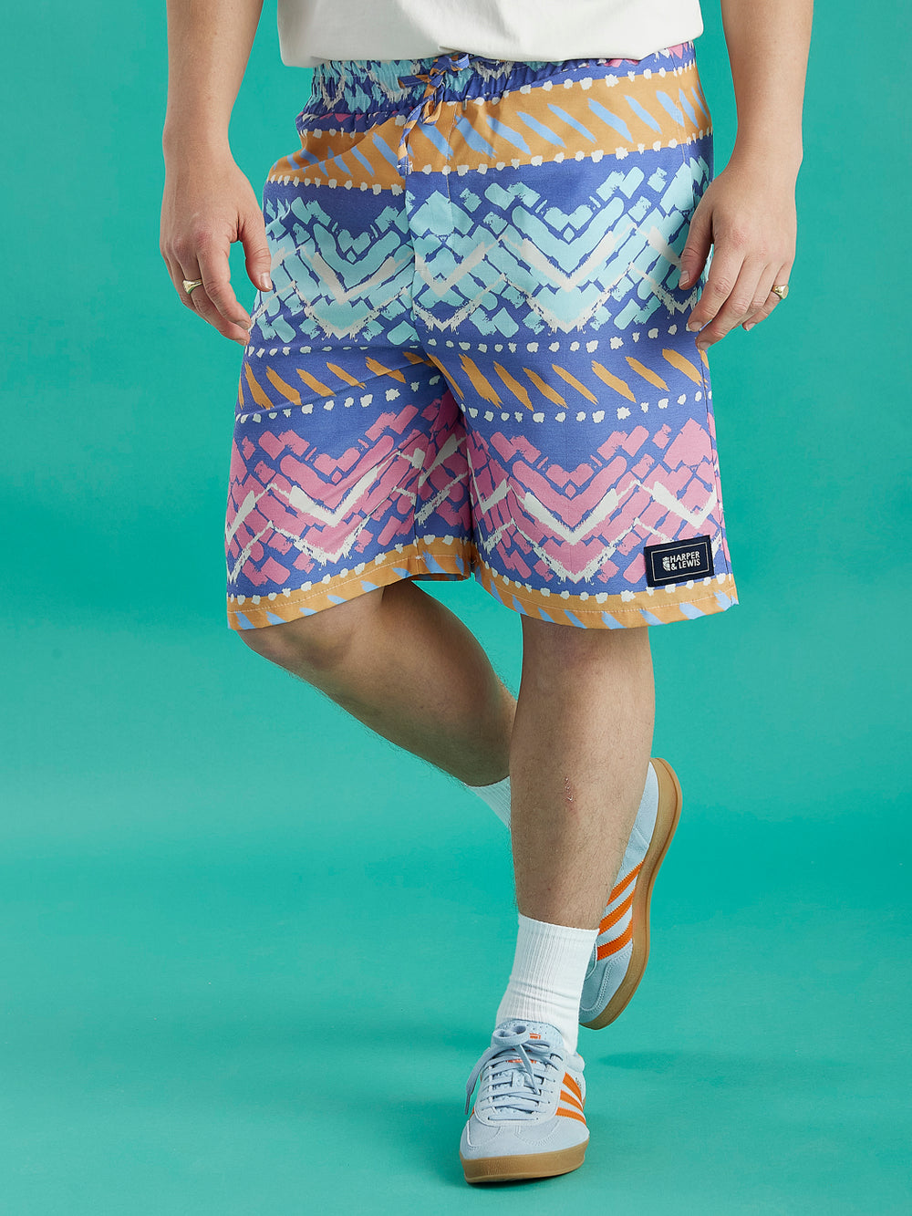 Model wearing the Cove Shorts featuring an abstract pattern.