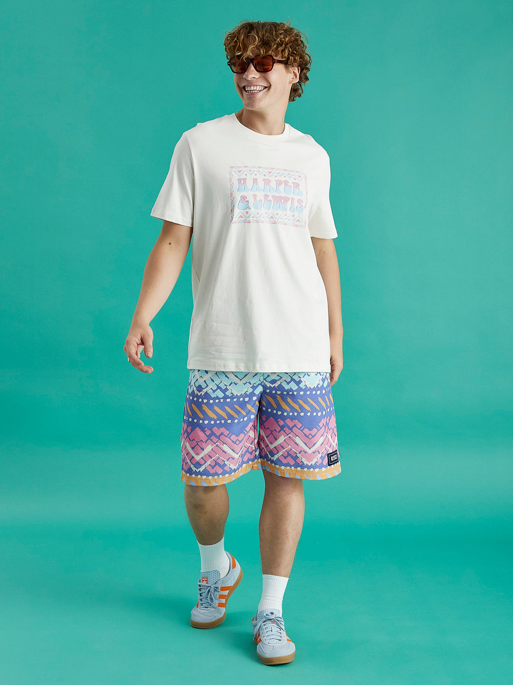 Male model wearing the Taran tee in cream, this tee features a big front chest graphic.