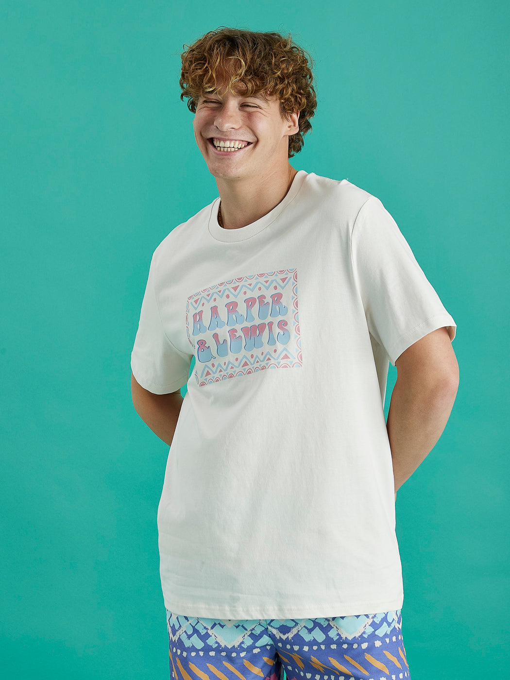 Male model wearing the Taran tee in cream, this tee is made from 100% cotton.