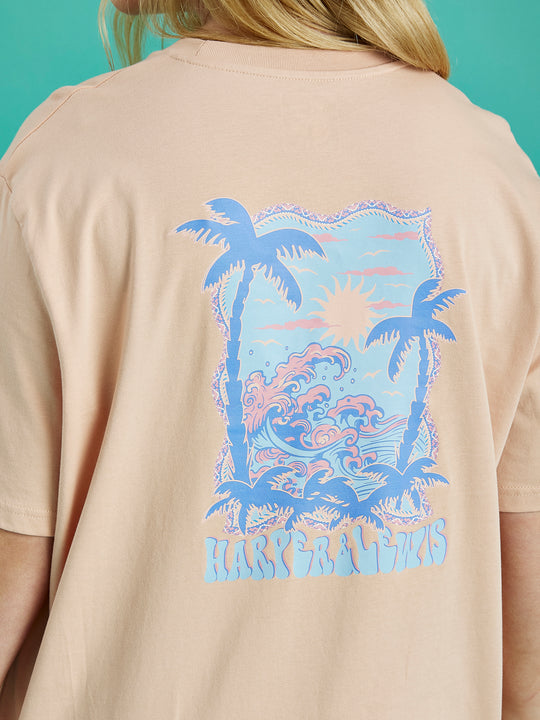 Detail shot of the back Tropical graphic on the Alwan tee in peach.