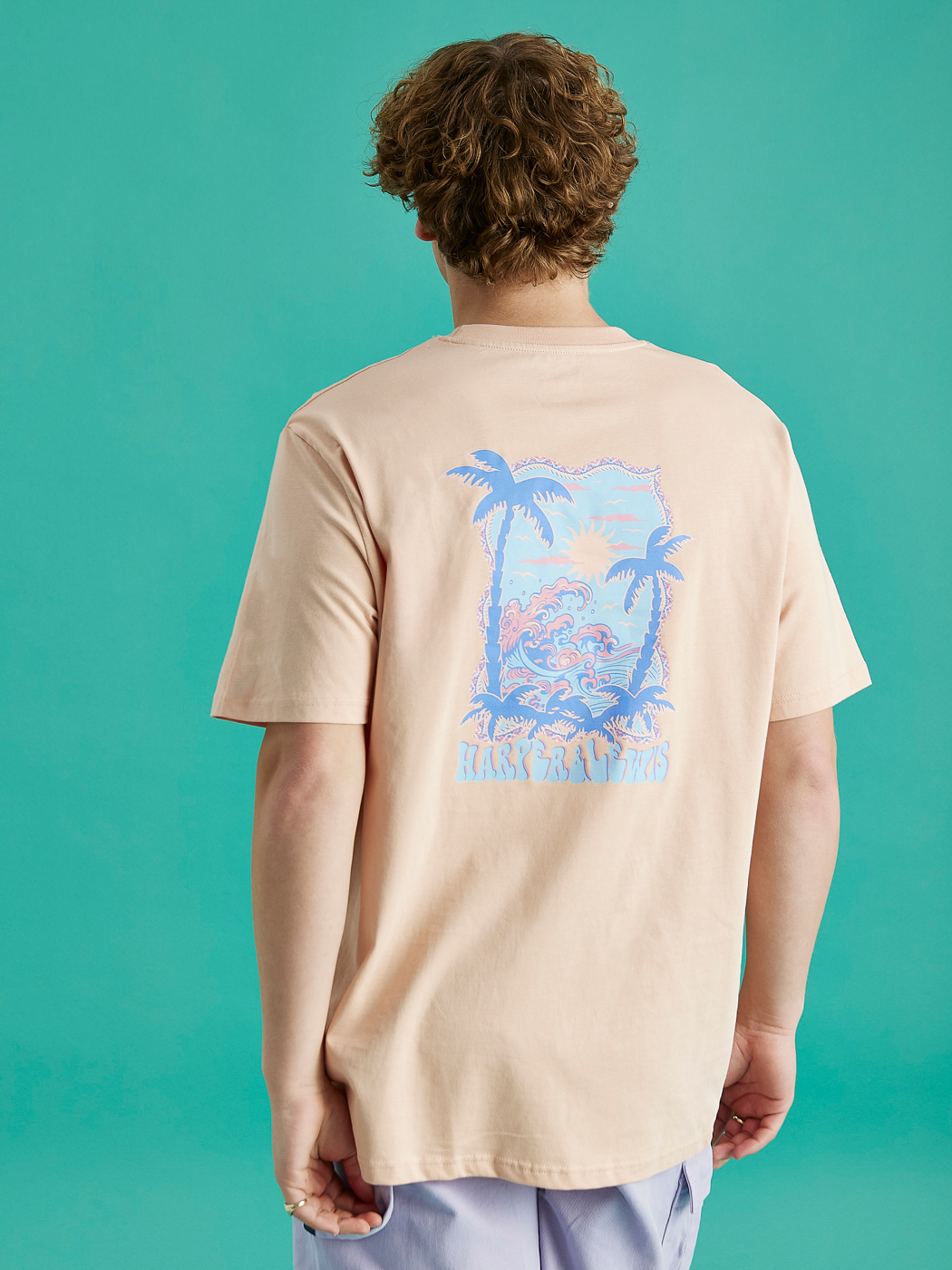 The colour of this Alwan tee is a peach colour similar to a beige.