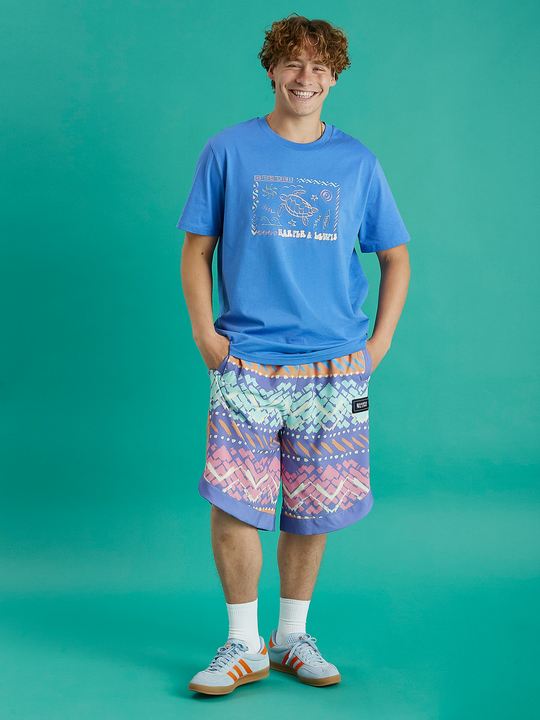 Male model wearing this Royal Blue tshirt casually with some patterned shorts.