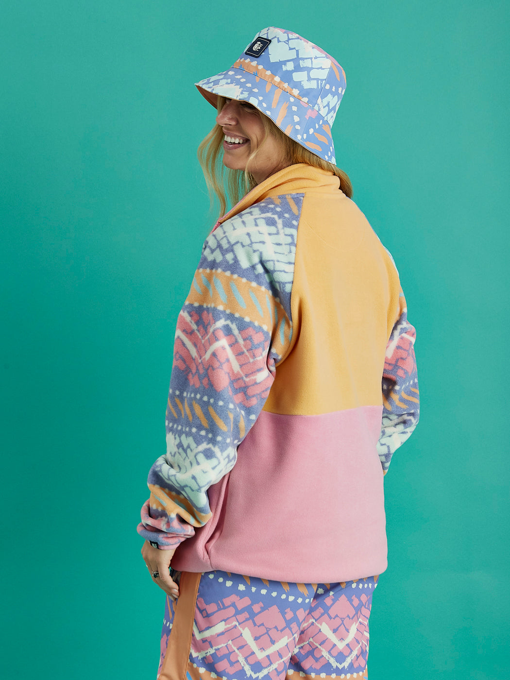 Back view of the Sutton fleece on model, showing full coverage of retro-inspired pattern and cozy fleece texture.