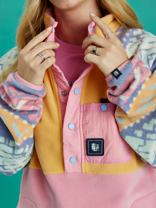 Close up of the details, this features a badge on the front crinkle pocket and a badge on the cuff.