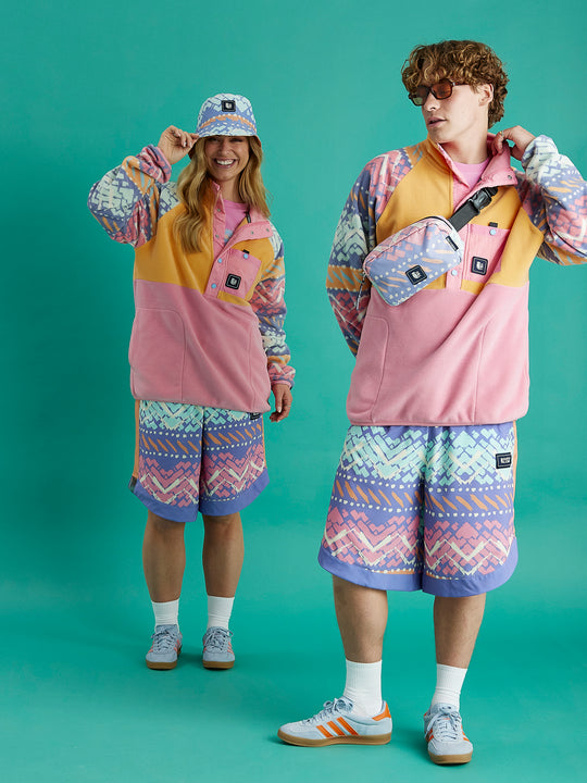 Both models wearing the Sutton Popper Neck Fleece in Pink & Apricot with the festival pattern. Styled with the Jett shorts.