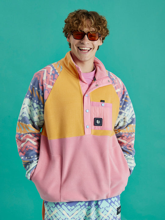 Male Model wears the Sutton fleece inspired by 90's culture, with vibrant colours and festival patterns.