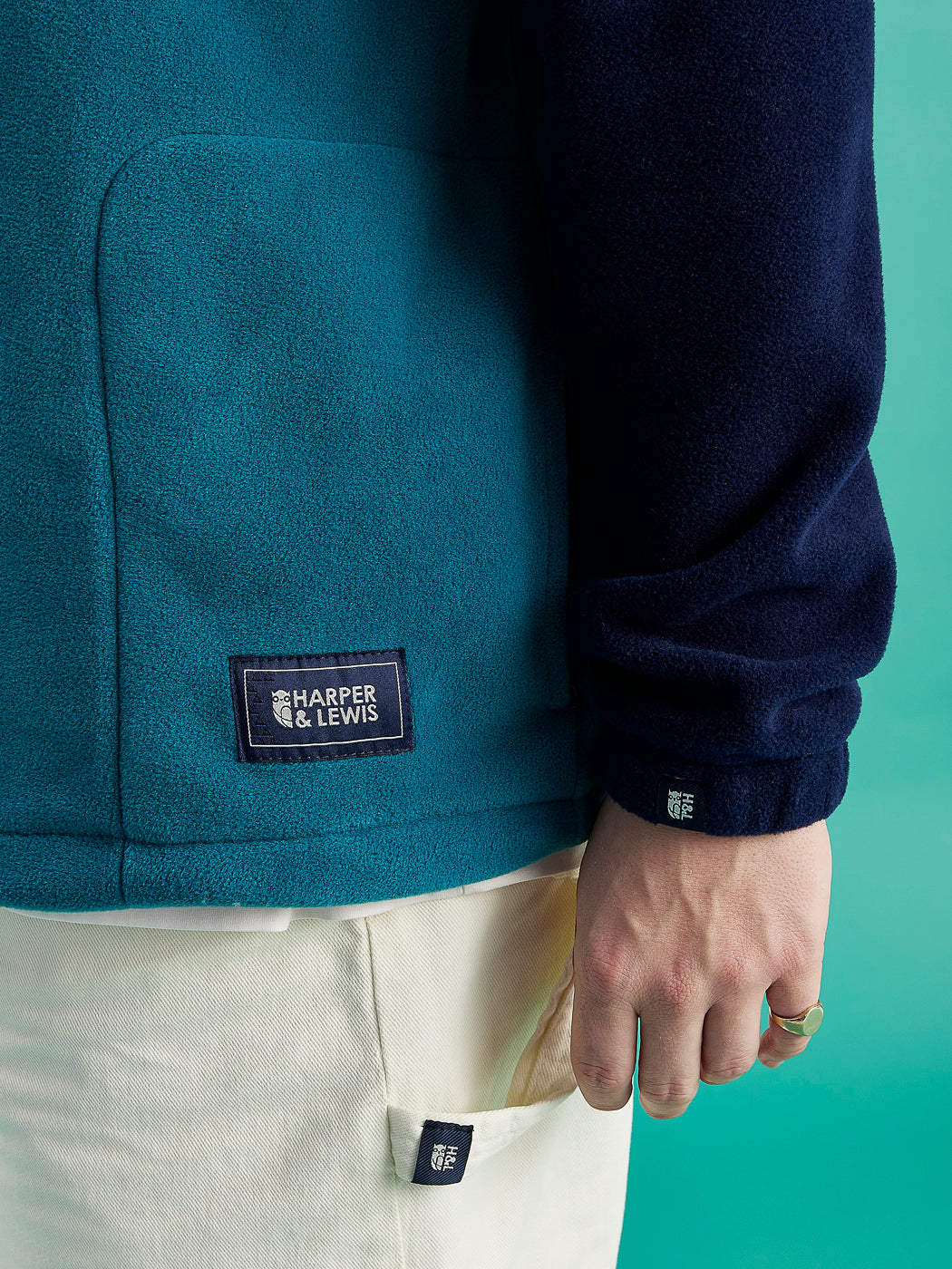 Navy detailing consists of, branded tabs on the pocket and sleeves, a woven badge on the back of the neck and a Branded zip puller on this all of print 1/4 zip fleece.