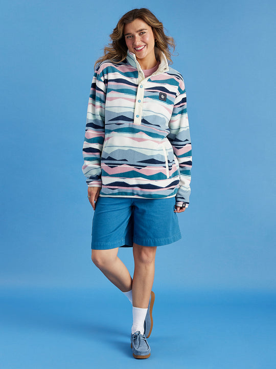 Full Length image of female model wearing the Tallow Fleece, this polar fleece features a Popper Neck with a branded snap buttons.