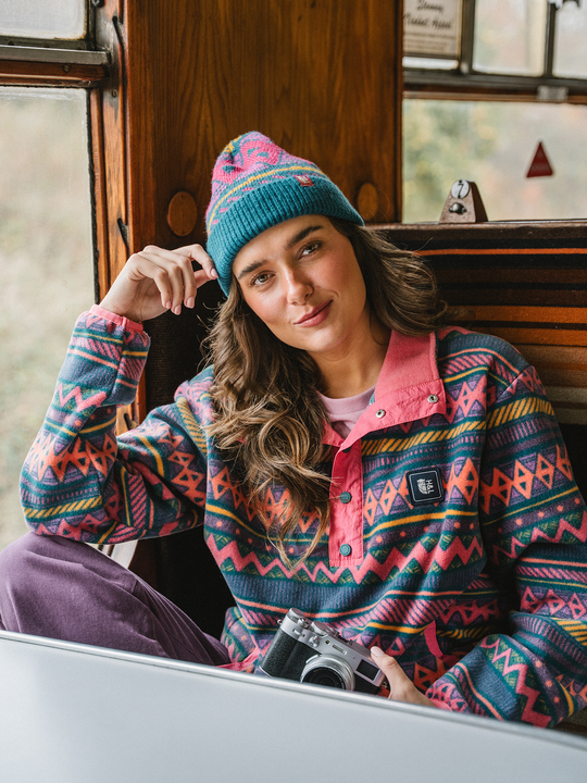 Lifestyle image of a female model wearing the Aztec pattern fleece jacket on an adventure
