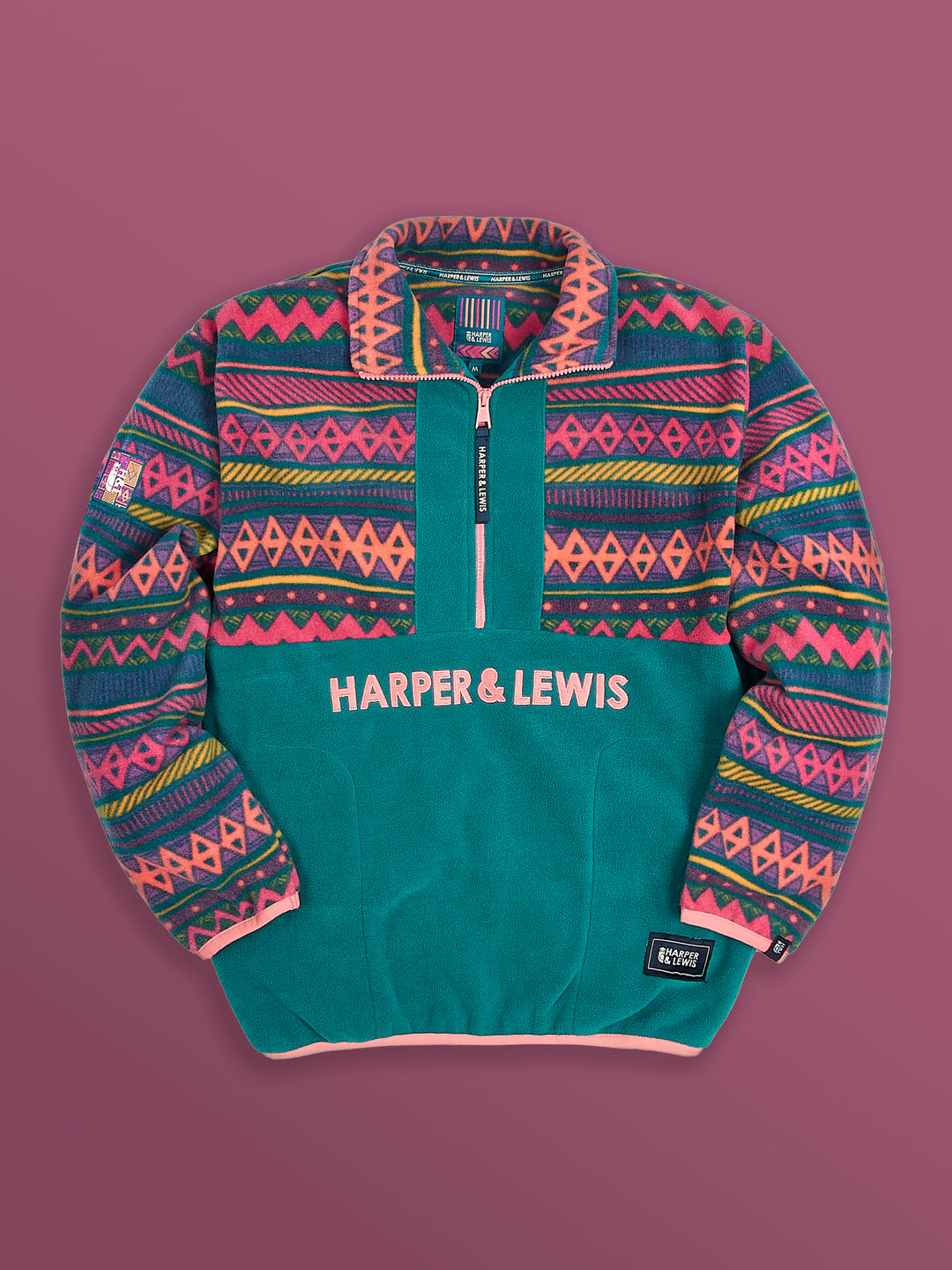 Flatlay image of the ztec and teal fleece, this shows the zip pulled down to show the pattern in the collar.