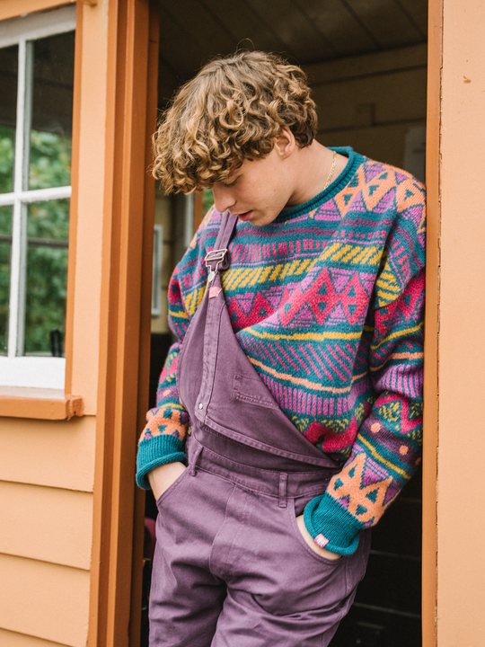 Male model wears the Aria dungarees in Deep Mulberry