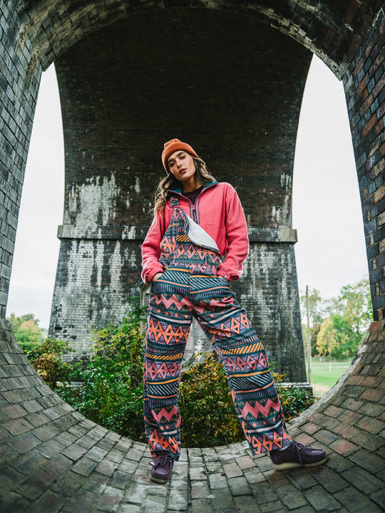 Female model wears the corduroy dungarees, which has a relaxed fit