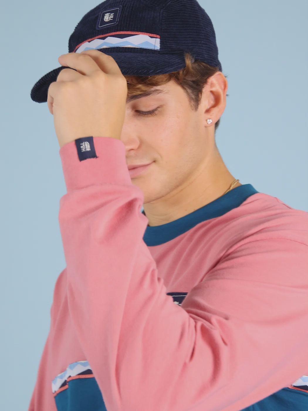 Details of the Navy branded badge on the chest of the t-shirt.