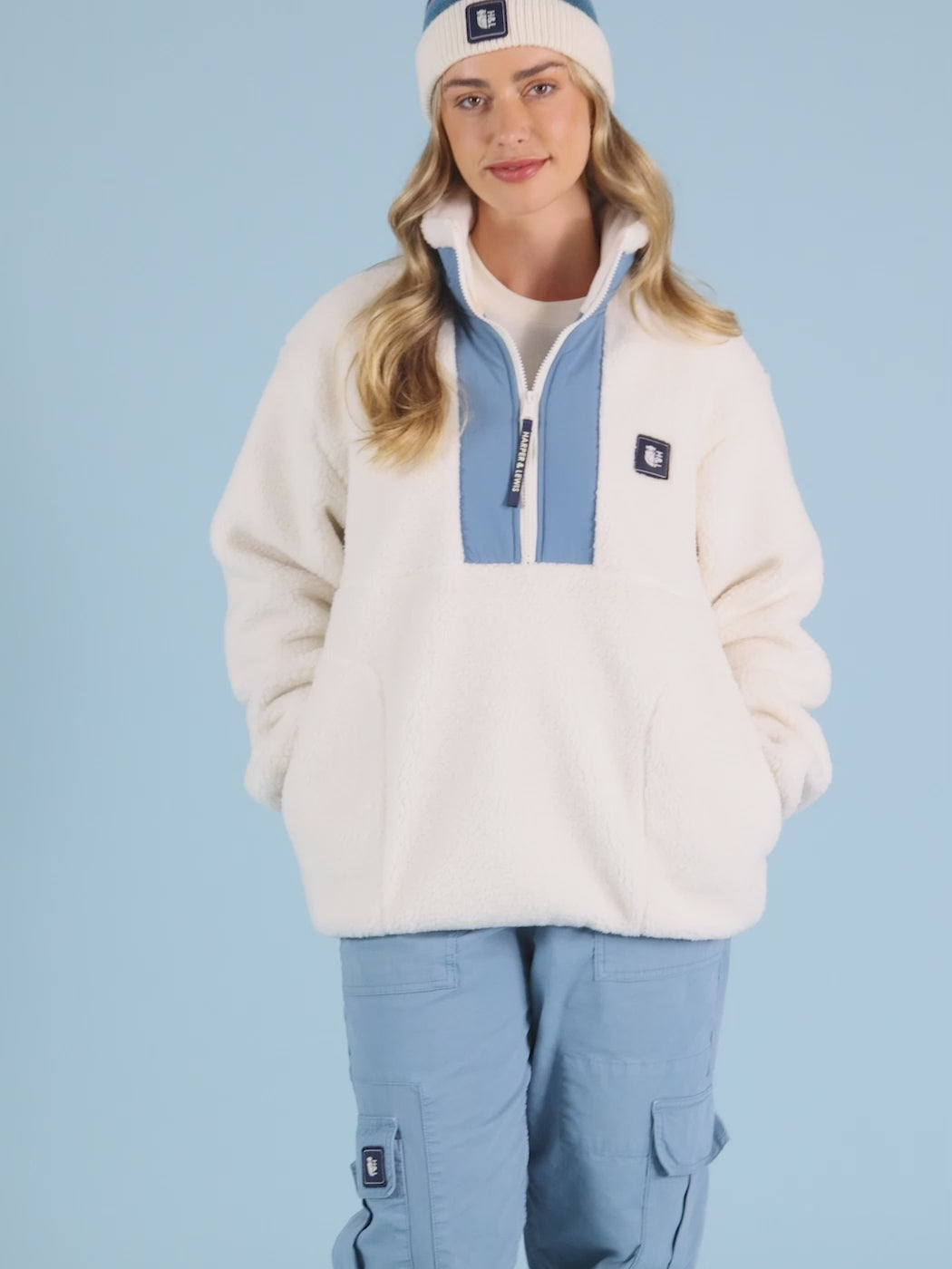 unisex Fleece in Cream with a quarter-zip collar, relaxed fit, and a cosy sherpa material.
