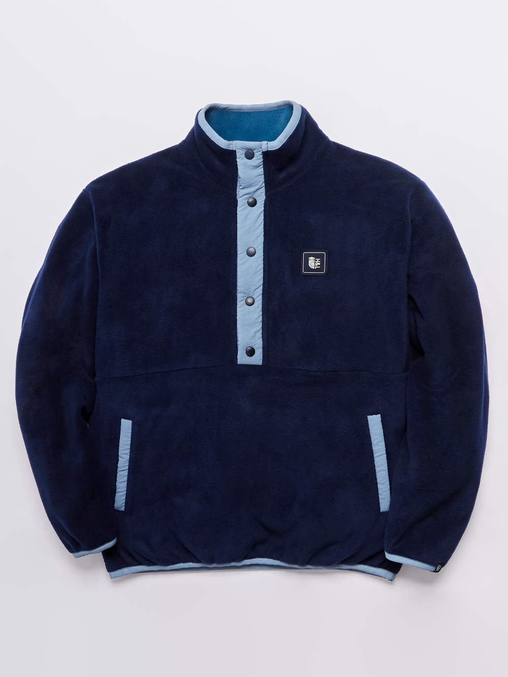 unisex Fleece in Navy with a Popper Neck Closure, relaxed fit, and Branded badge on chest.
